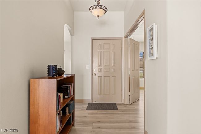 Entryway featuring light wood finished floors and arched walkways | Image 5