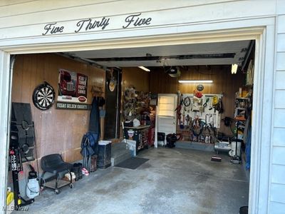 Garage featuring wood walls | Image 3