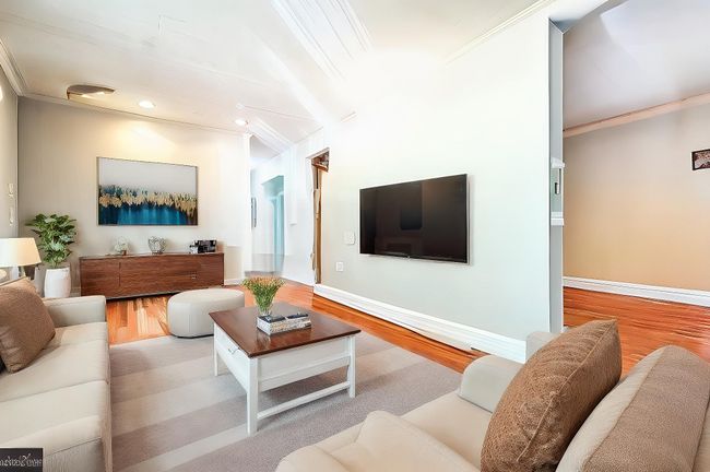 Living room featuring wood finished floors, crown molding, baseboards, and recessed lighting | Image 7