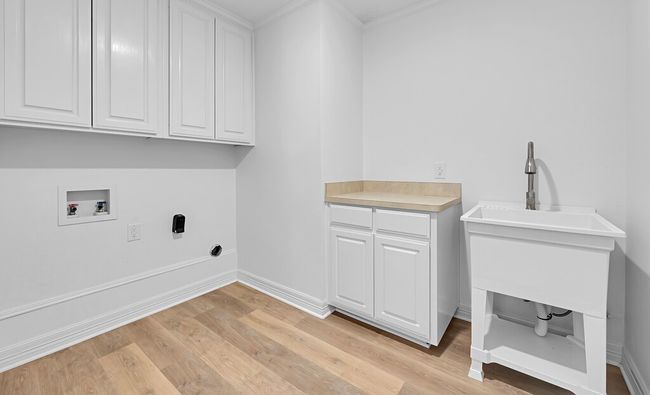 Great large utility room with cabinet space, and laundry sink | Image 17