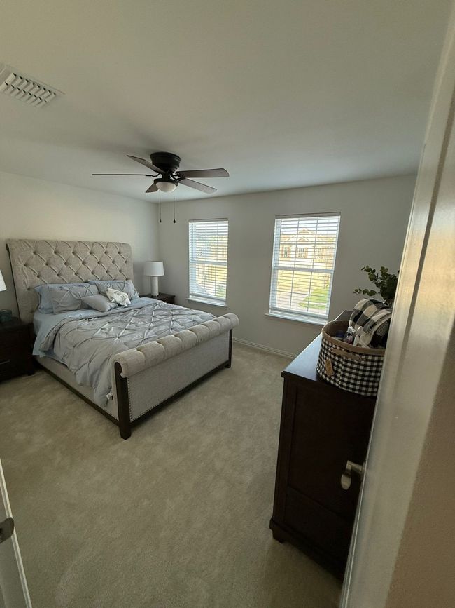 Bedroom featuring a ceiling fan and light carpet | Image 15