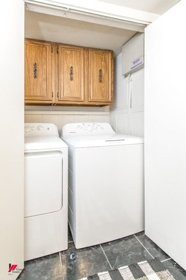 Laundry area with independent washer and dryer and cabinet space | Image 26