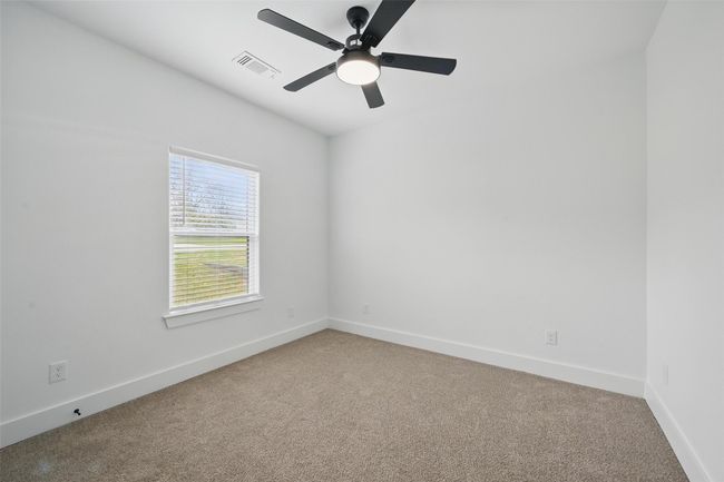 Carpeted spare room with visible vents, baseboards, and a ceiling fan | Image 10