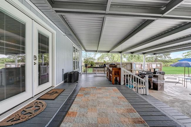 Massive back patio with new cover is the perfect space to entertain guest. | Image 19