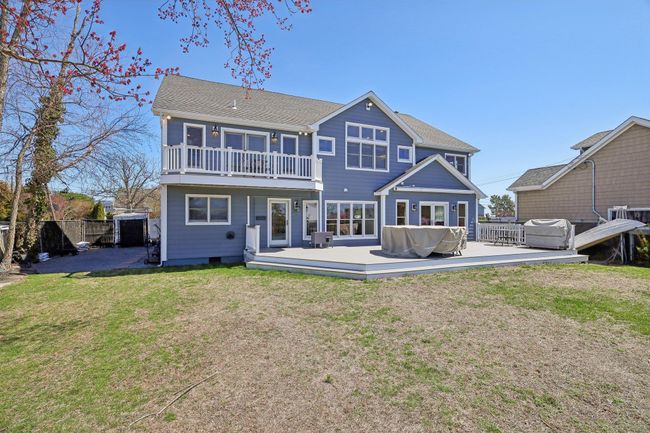 Rear view of property featuring a yard, fence, and a balcony | Image 42