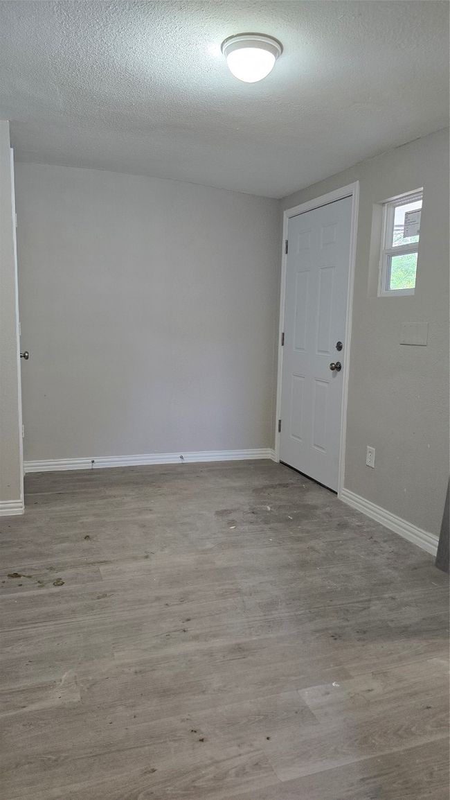 Spare room with baseboards, wood finished floors, and a textured ceiling | Image 18
