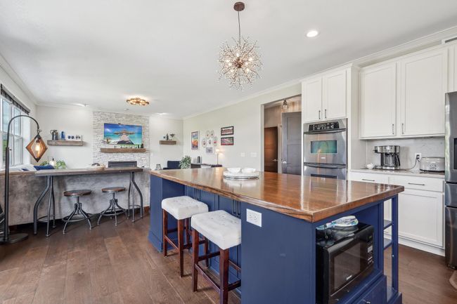 Custom island features a built-in wine rack | Image 12