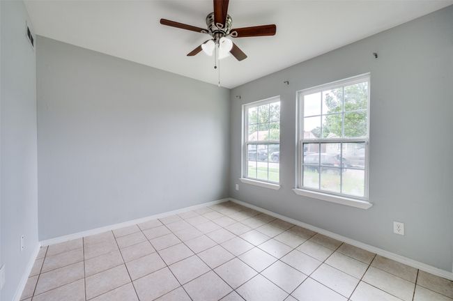 Unfurnished room with a ceiling fan and light tile patterned floors | Image 15