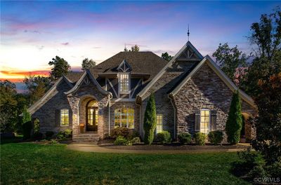 This home includes outdoor lighting, and a fenced-in backyard. | Image 2