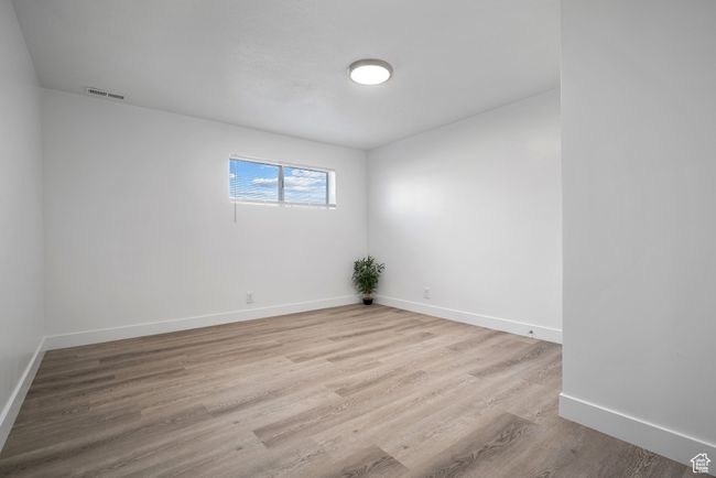 Empty room featuring baseboards and wood finished floors | Image 12