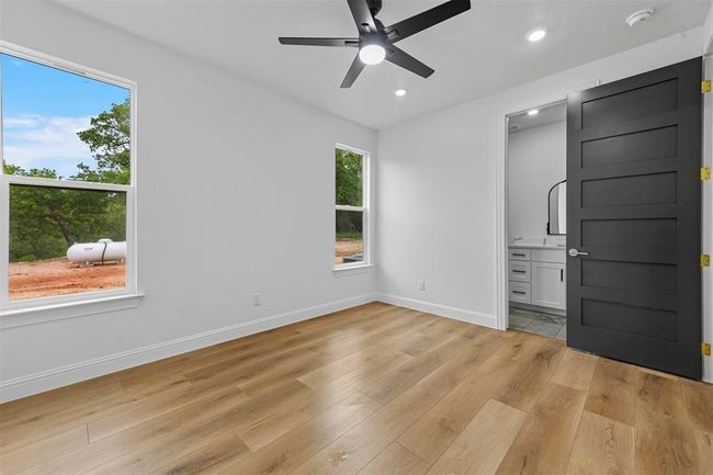 Empty room with light hardwood / wood-style flooring and ceiling fan | Image 29