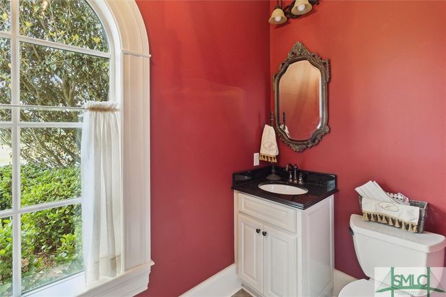 Located just inside the garage entrance is a guest powder room. | Image 17