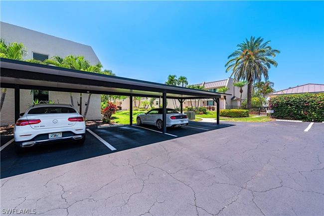 View of parking / parking lot featuring a carport | Image 12