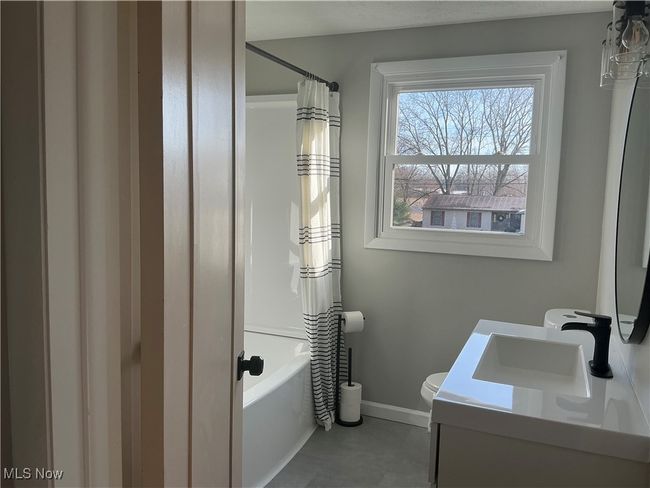 Full bathroom featuring vanity, shower / tub combo, and toilet | Image 13