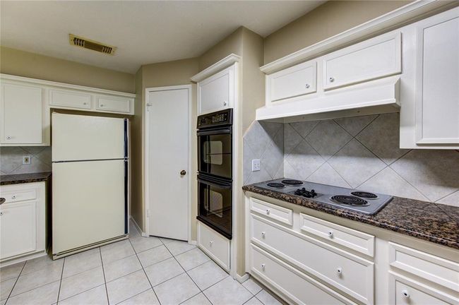 Another view of the kitchen. Walk-in pantry through door. | Image 12