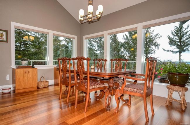 Dining space with lofted ceiling, lovely views and hardwood floors | Image 5