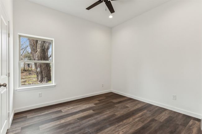 Unfurnished room with ceiling fan, dark wood-style flooring, and recessed lighting | Image 22