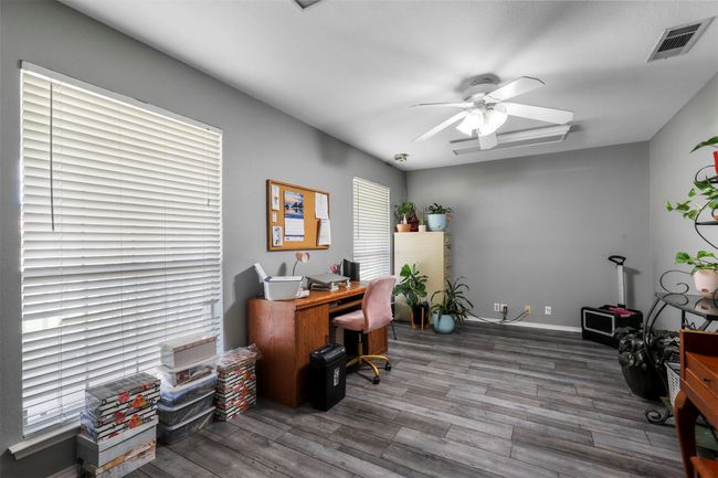 Office area featuring dark hardwood / wood-style floors and ceiling fan | Image 22