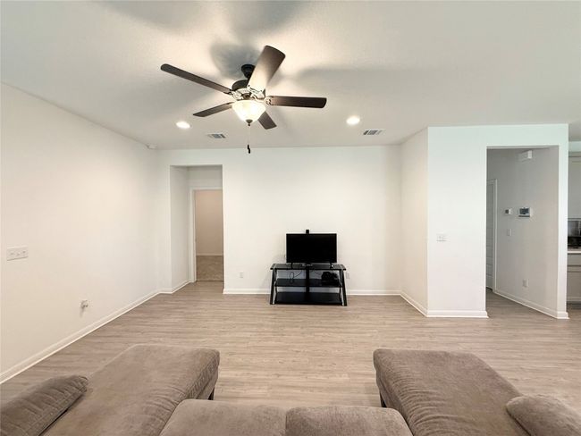 Living area featuring ceiling fan, light wood-type flooring, recessed lighting, and baseboards | Image 7