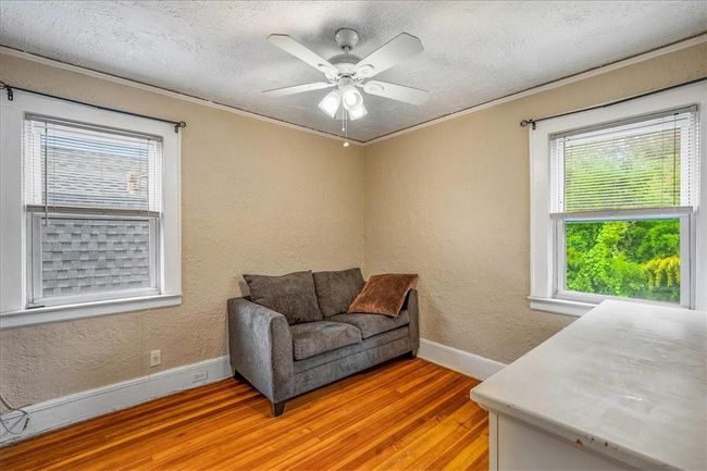 Sitting room featuring ceiling fan, wood-type flooring, and a wealth of natural light | Image 32