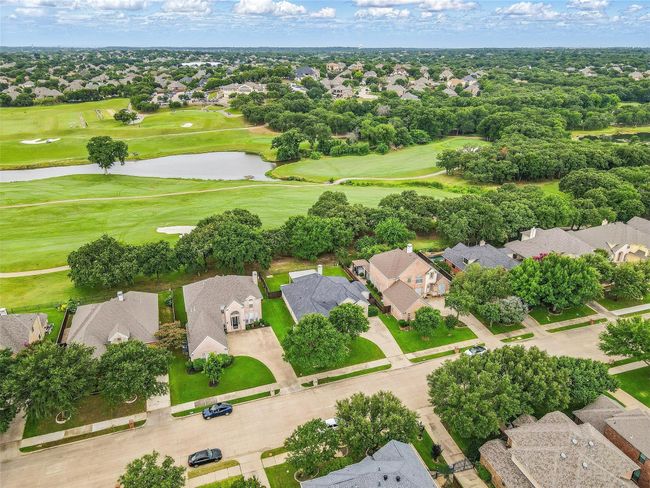 Aerial perspective of suburban area featuring a local golf course and a large body of water | Image 34