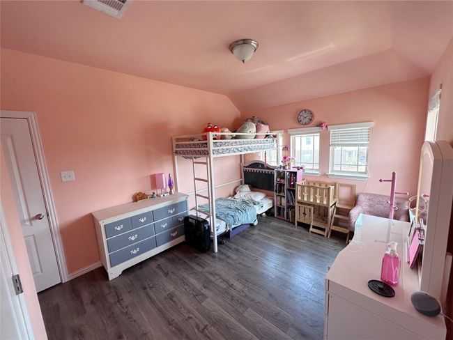 Upstairs bedroom with pink walls, dark wood-style floors and vaulted ceiling | Image 24