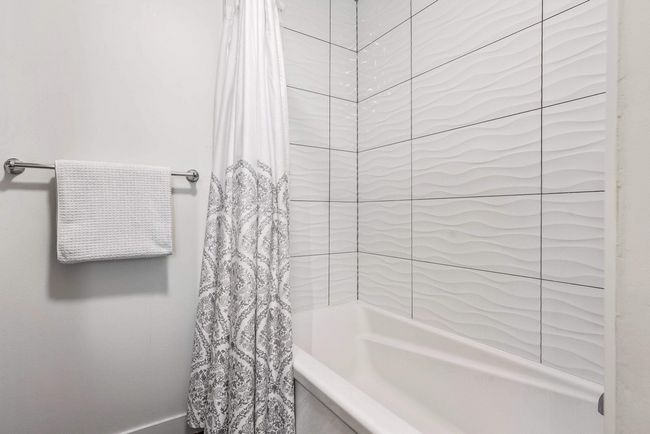 Bathroom featuring shower / bath combination with curtain | Image 20