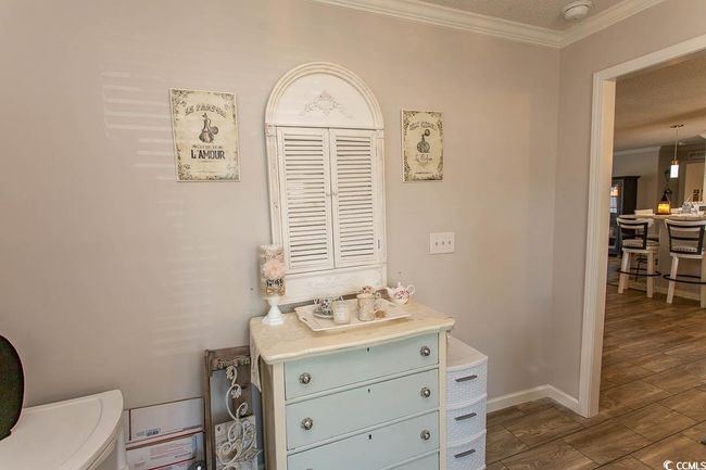 Interior details with baseboards, wood finished floors, a textured ceiling, and crown molding | Image 14