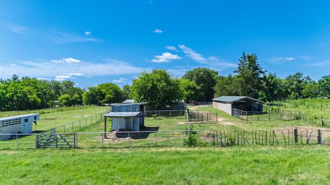 View of yard featuring an outdoor structure, an exterior structure, and a rural view | Image 35