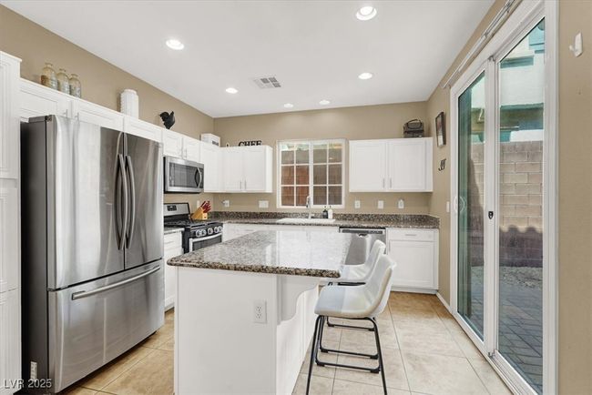 Kitchen featuring stainless steel appliances, a sink, white cabinetry, and recessed lighting | Image 8