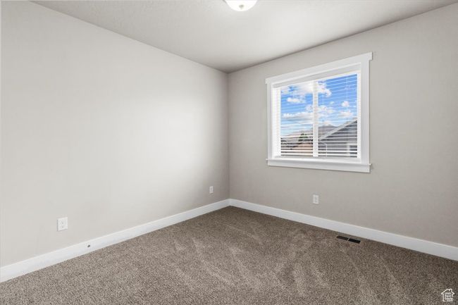 Unfurnished room with dark carpet and baseboards | Image 31