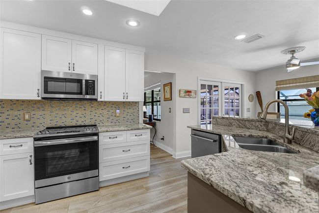 Kitchen features updated Stainless Steel Appliances, Granite countertops and solid wood cabinetry | Image 13