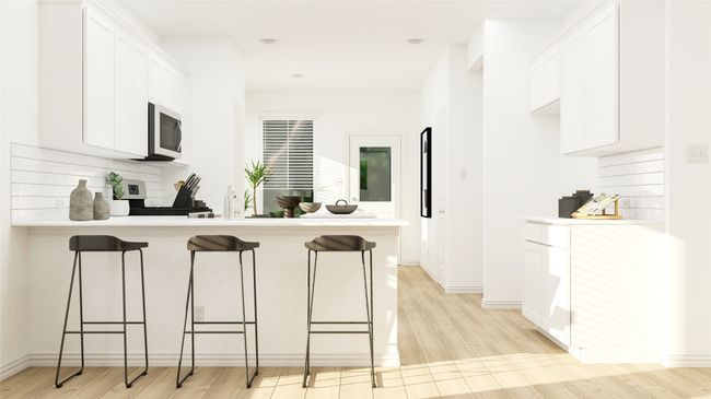 Kitchen with stainless steel microwave, a peninsula, a kitchen breakfast bar, white cabinets, and light countertops | Image 10