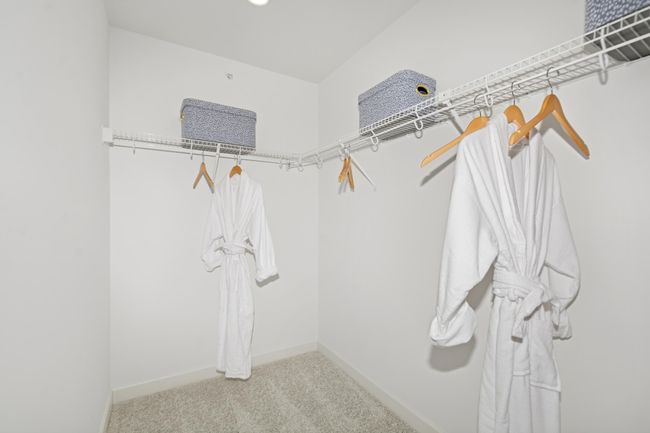 (Photo of decorated model, actual home's finishes will vary) Owner's suite walk-in closet, sure to provide more than enough space for all! | Image 14