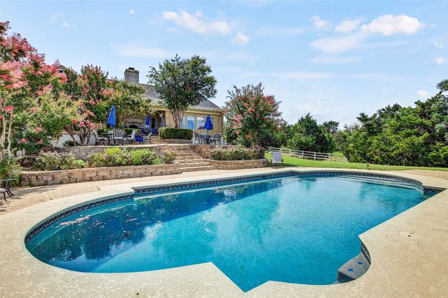 Swimming pool with a patio | Image 33