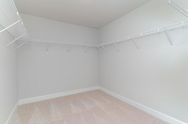 Spacious closet with light colored carpet | Image 19