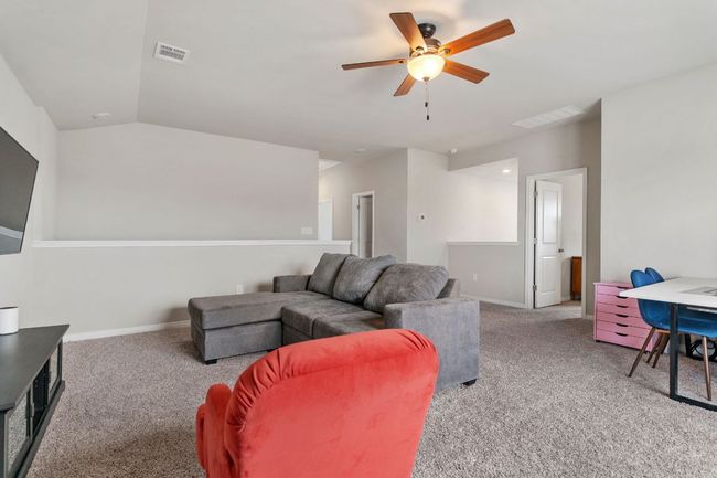 Living room featuring carpet floors, a ceiling fan, and lofted ceiling | Image 20