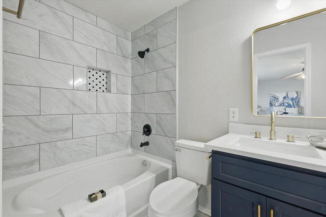 Full bathroom featuring vanity, shower / bath combination, and a ceiling fan | Image 20