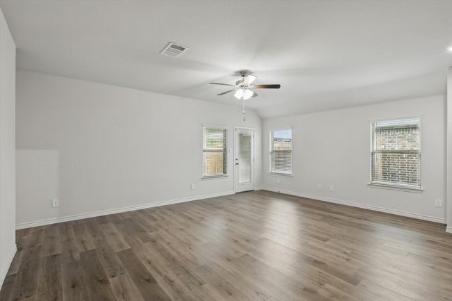 Spare room with a ceiling fan and wood finished floors | Image 16