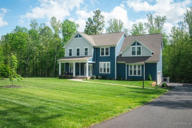 View of front of house featuring a porch, a shingled roof, and a front yard | Image 42