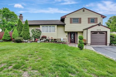 Welcome home to this beautiful Split Level Style house. 3 Bedrooms with 2 Full Baths. One car garage and large driveway for parking additional cars. | Image 1