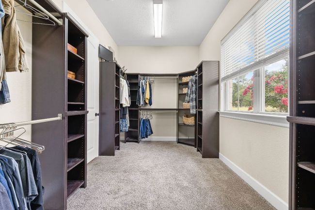 Large walk-in closet with additional storage closet. | Image 21