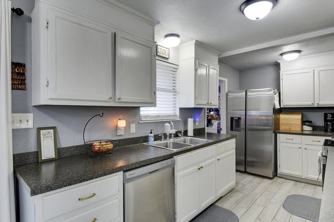 Stainless appliances, and lovely tile flooring. | Image 13