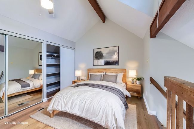 Bedroom featuring lofted ceiling with beams, light wood-type flooring, and baseboards | Image 17