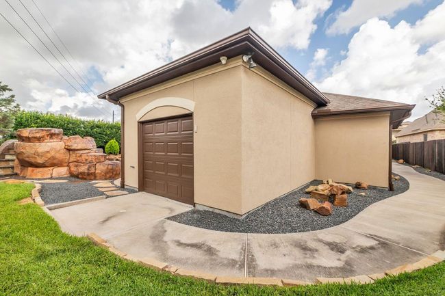 This custom-built storage shed offers the perfect solution for all your storage needs. Thoughtfully designed with durable materials and a spacious interior, it provides ample room for tools, lawn equipment, seasonal décor, and more. A stylish exterior complements the home while adding practical functionality to the backyard. | Image 38