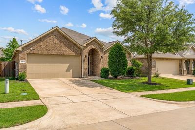 View of front of house featuring a front yard and a garage | Image 1