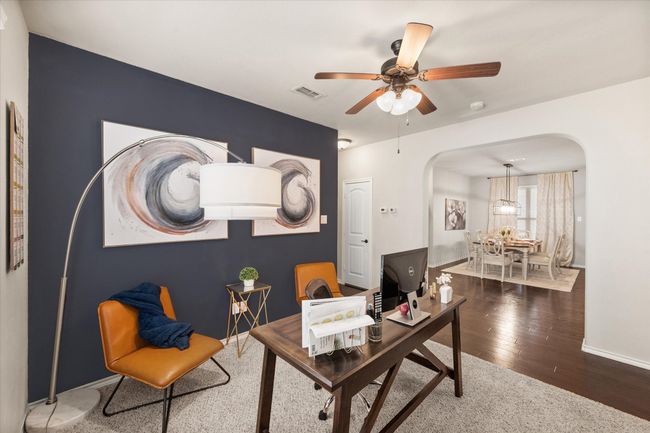 Office space featuring visible vents, baseboards, arched walkways, ceiling fan, and wood finished floors | Image 10