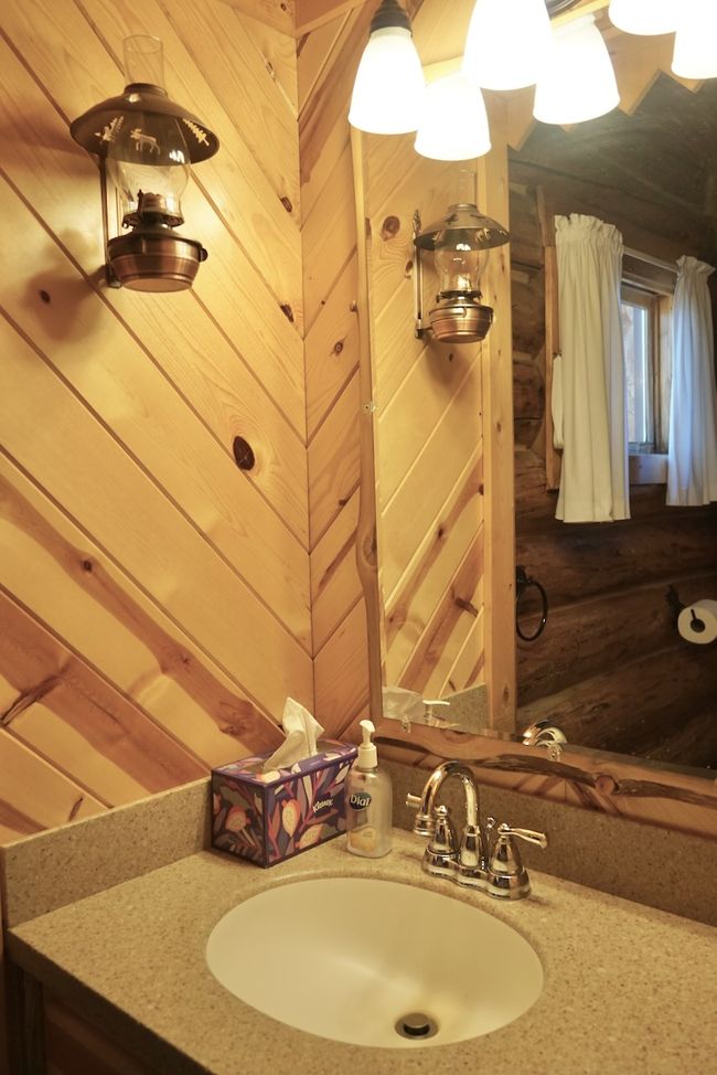 Bathroom with wood walls and vanity | Image 33
