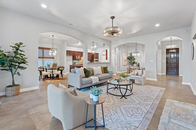 Living area with arched walkways, a chandelier, recessed lighting, and baseboards | Image 11