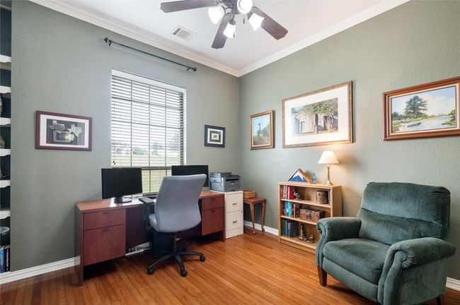 Home office with ceiling fan, light wood-style floors, and ornamental molding | Image 13